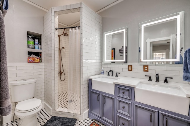2220 Mistletoe Blvd, Fort Worth, TX 76110 - bathroom featuring tile walls, toilet, tiled shower, double vanity, and tile patterned flooring