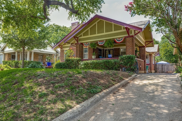 2220 Mistletoe Blvd, Fort Worth, TX 76110 - view of front of property featuring brick siding, covered porch, and a chimney