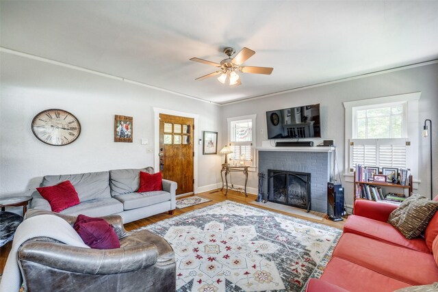 2220 Mistletoe Blvd, Fort Worth, TX 76110 - living room featuring ceiling fan, plenty of natural light, a brick fireplace, wood finished floors, and ornamental molding