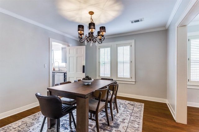3913 Modlin Ave, Fort Worth, TX 76107 - dining room with a chandelier, healthy amount of natural light, dark wood-type flooring, and crown molding