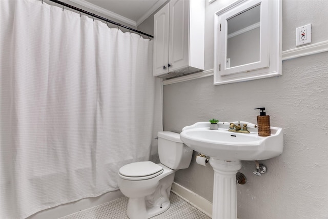 3913 Modlin Ave, Fort Worth, TX 76107 - bathroom with ornamental molding, toilet, tile patterned floors, and baseboards