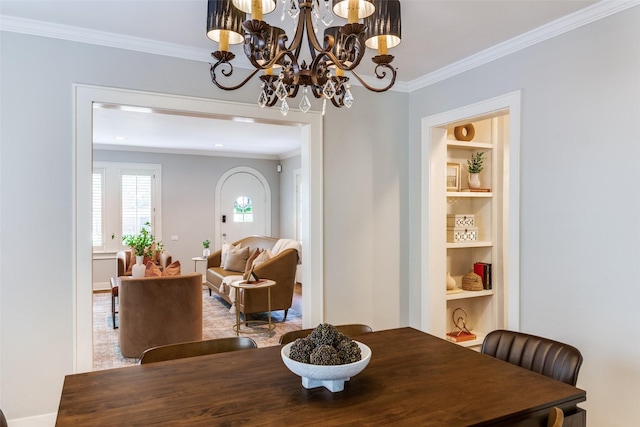 3913 Modlin Ave, Fort Worth, TX 76107 - dining space with crown molding, built in features, a chandelier, and baseboards