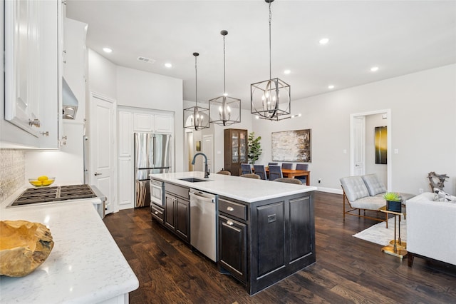 8229 Halifax, The Colony, TX 75056 - kitchen featuring stainless steel appliances, a sink, white cabinetry, dark wood finished floors, and recessed lighting