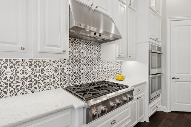 8229 Halifax, The Colony, TX 75056 - kitchen with under cabinet range hood, stainless steel appliances, white cabinets, decorative backsplash, and light stone counters