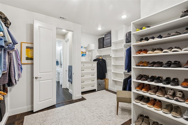 8229 Halifax, The Colony, TX 75056 - walk in closet featuring dark wood-style floors