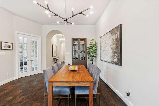8229 Halifax, The Colony, TX 75056 - dining area featuring arched walkways, a chandelier, french doors, wood finished floors, and baseboards