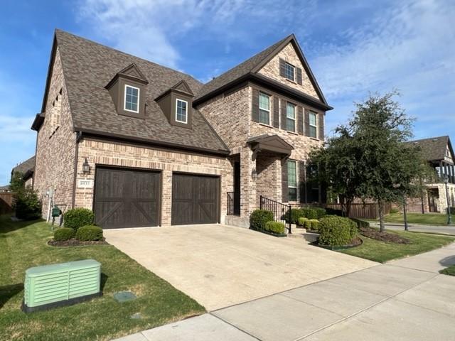 8533 Pine Valley Dr, Mckinney, TX 75070 - view of front of home with concrete driveway, brick siding, an attached garage, and a shingled roof