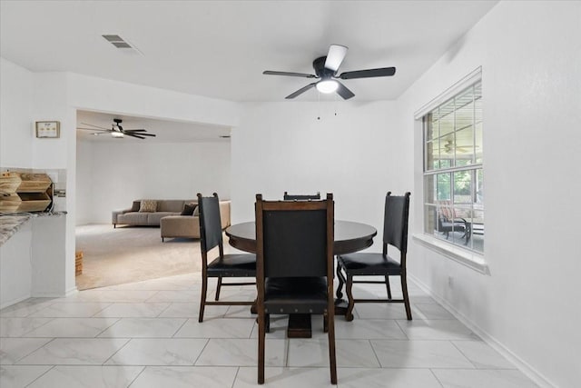 201 Wilson St, Whitesboro, TX 76273 - dining space featuring light marble finish flooring, a ceiling fan, and baseboards