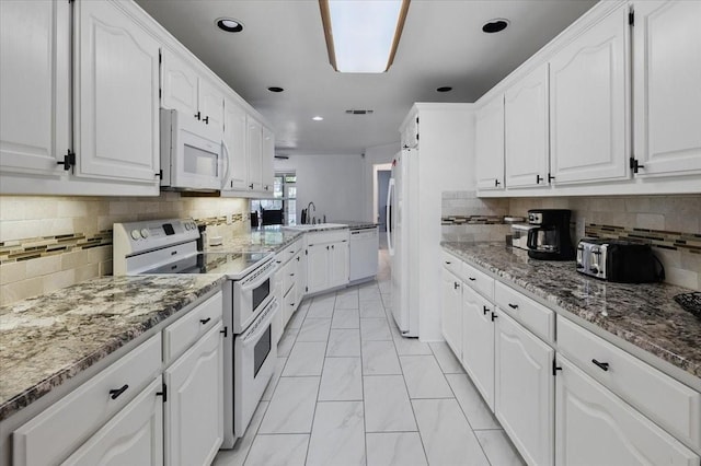 201 Wilson St, Whitesboro, TX 76273 - kitchen featuring white appliances, white cabinets, light marble finish flooring, a sink, and recessed lighting
