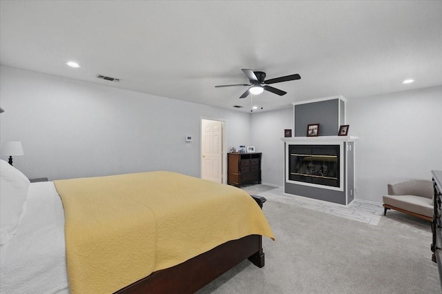 201 Wilson St, Whitesboro, TX 76273 - bedroom featuring light carpet, recessed lighting, ceiling fan, and a glass covered fireplace