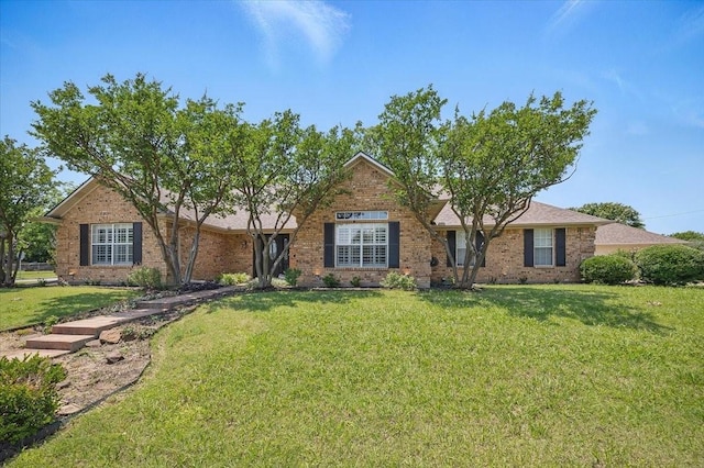 201 Wilson St, Whitesboro, TX 76273 - view of front of house featuring a front lawn and brick siding