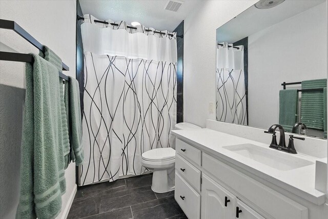 201 Wilson St, Whitesboro, TX 76273 - bathroom featuring vanity, toilet, tile patterned floors, and a shower with curtain