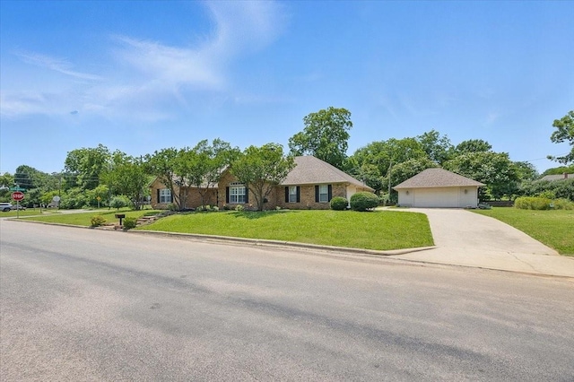201 Wilson St, Whitesboro, TX 76273 - ranch-style home featuring a front yard, concrete driveway, and a detached garage