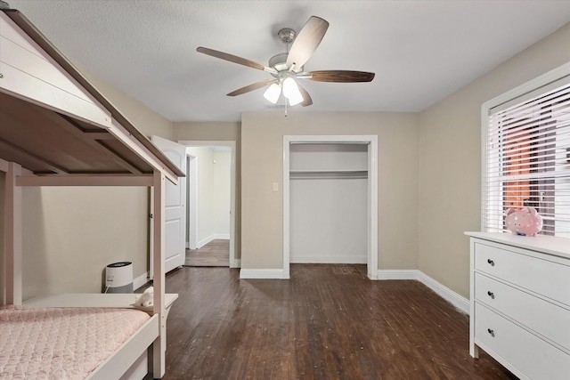 3200 Haltom Rd, Haltom City, TX 76117 - bedroom featuring dark wood finished floors, baseboards, a closet, and ceiling fan