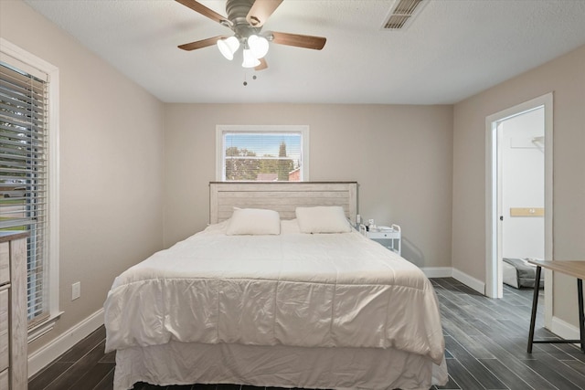 3200 Haltom Rd, Haltom City, TX 76117 - bedroom with dark wood-style flooring, baseboards, and ceiling fan