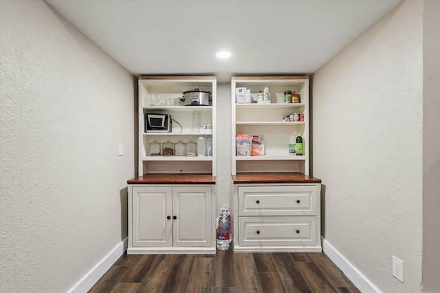 3200 Haltom Rd, Haltom City, TX 76117 - detailed view of wood finished floors, baseboards, and a textured wall