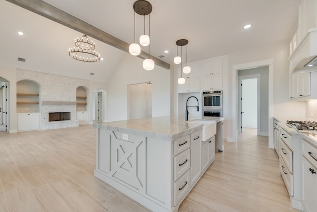 160 Maci Dr, Waxahachie, TX 75167 - kitchen featuring light wood-style flooring, light stone countertops, white cabinets, a sink, and recessed lighting
