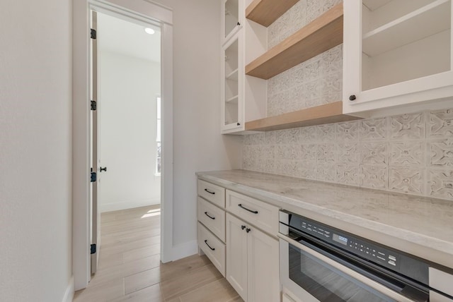 160 Maci Dr, Waxahachie, TX 75167 - kitchen with open shelves, backsplash, baseboards, oven, and white cabinetry