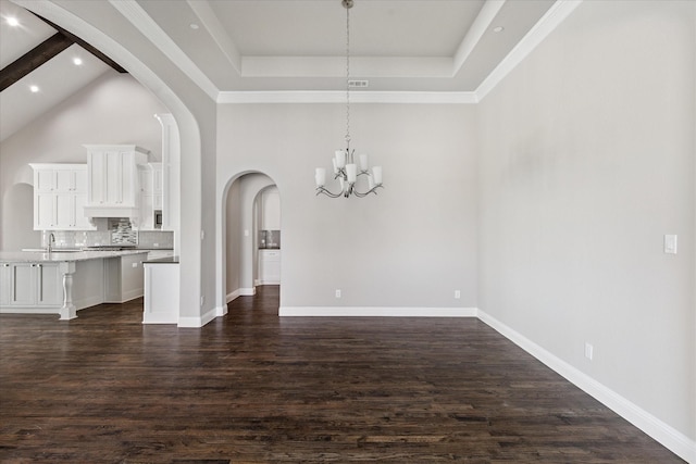 1211 Logan Trl, Lucas, TX 75002 - unfurnished dining area with a chandelier, dark wood finished floors, arched walkways, a high ceiling, and a raised ceiling