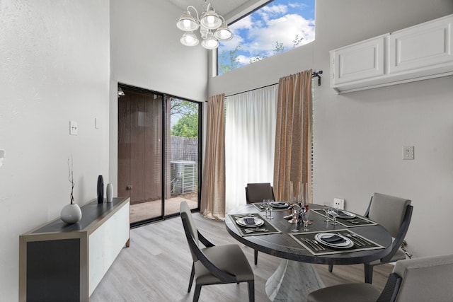 2526 Butterfield Dr, Fort Worth, TX 76133 - dining room featuring a chandelier, light wood finished floors, and a towering ceiling