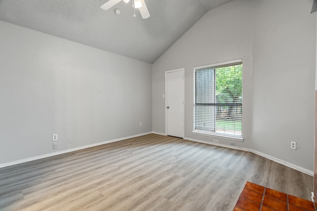 2526 Butterfield Dr, Fort Worth, TX 76133 - empty room featuring ceiling fan, wood finished floors, vaulted ceiling, and baseboards