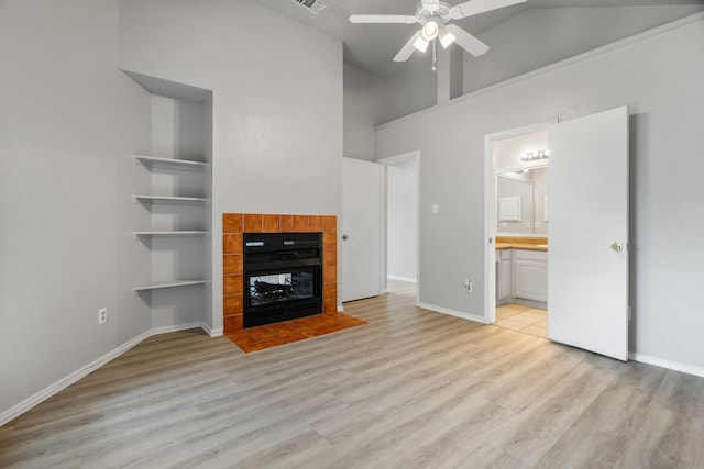 2526 Butterfield Dr, Fort Worth, TX 76133 - unfurnished living room with ceiling fan, light wood finished floors, a fireplace, high vaulted ceiling, and baseboards