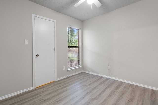 2526 Butterfield Dr, Fort Worth, TX 76133 - unfurnished room featuring light wood-type flooring, a textured ceiling, a ceiling fan, and baseboards