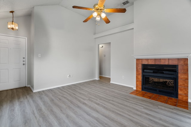 2526 Butterfield Dr, Fort Worth, TX 76133 - unfurnished living room featuring high vaulted ceiling, wood finished floors, ceiling fan, baseboards, and a tile fireplace