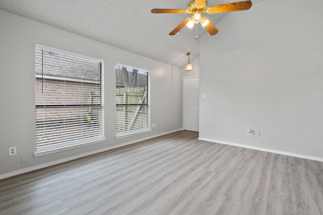 2526 Butterfield Dr, Fort Worth, TX 76133 - empty room featuring healthy amount of natural light, wood finished floors, a ceiling fan, baseboards, and lofted ceiling