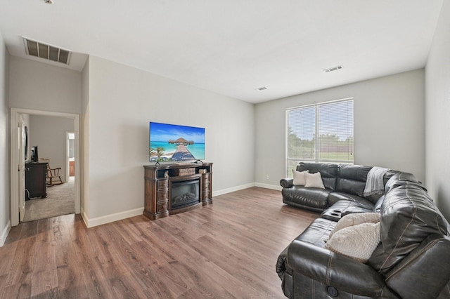 711 Mason Ln, Waxahachie, TX 75167 - living room featuring wood finished floors, baseboards, and a fireplace