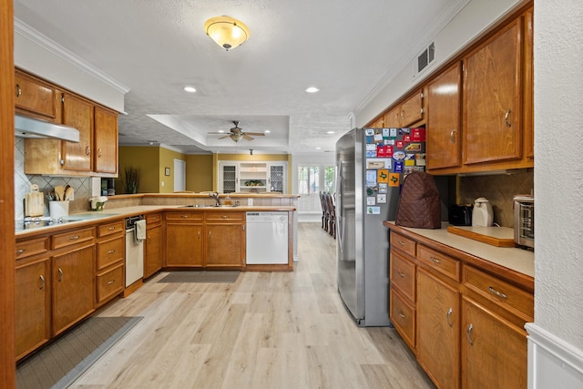 1407 S Alamo Rd, Rockwall, TX 75087 - kitchen with white dishwasher, a sink, light wood-type flooring, a peninsula, and a ceiling fan
