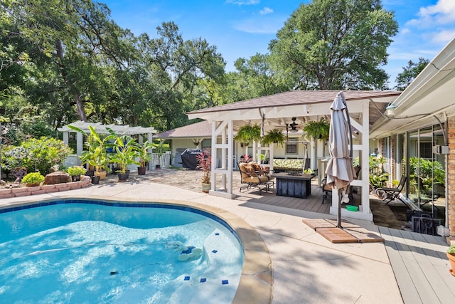 1407 S Alamo Rd, Rockwall, TX 75087 - swimming pool featuring a deck, ceiling fan, an outdoor living space with a fire pit, and a patio