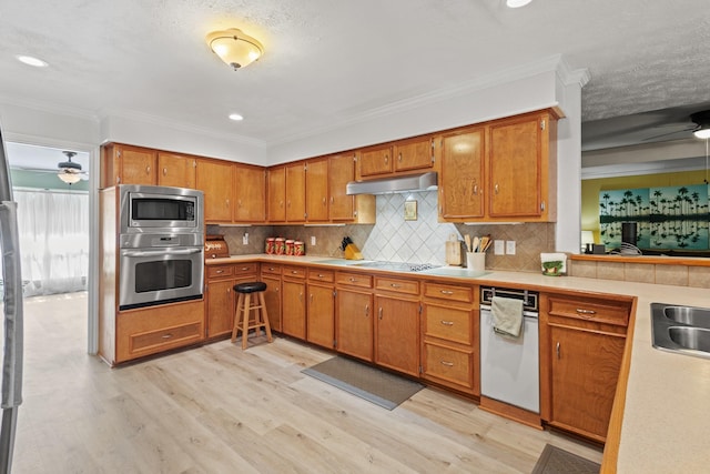 1407 S Alamo Rd, Rockwall, TX 75087 - kitchen with appliances with stainless steel finishes, a ceiling fan, light wood-style floors, crown molding, and light countertops