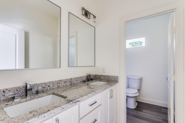 101 Jim Walters Dr, Runaway Bay, TX 76426 - full bath with toilet, double vanity, baseboards, and wood finished floors