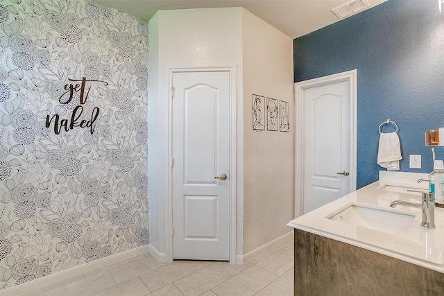 1112 Goldenrod Dr, Godley, TX 76044 - bathroom featuring tile patterned flooring, baseboards, and double vanity