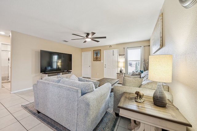 3350 Margay Run, Crandall, TX 75114 - living area featuring light tile patterned flooring, ceiling fan, and baseboards