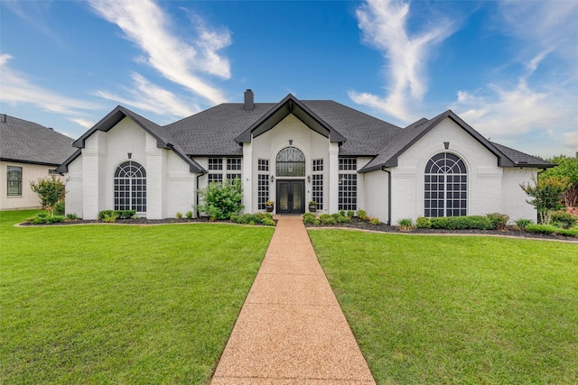 24 Shady Dale Ln, Rockwall, TX 75032 - french country inspired facade with french doors, brick siding, a chimney, and a front lawn