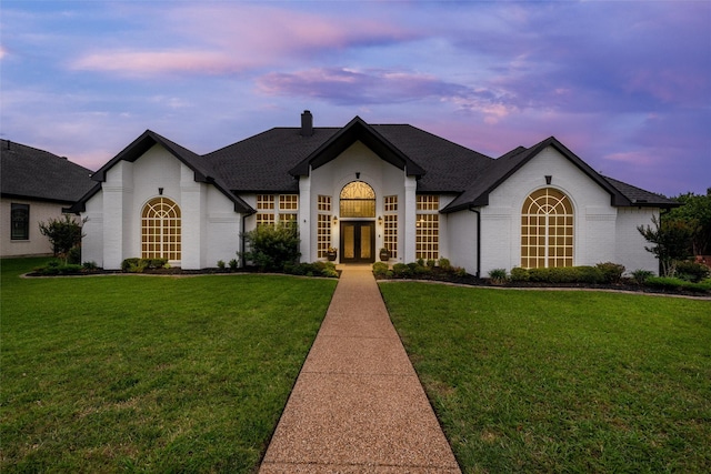 24 Shady Dale Ln, Rockwall, TX 75032 - french country style house with french doors, a chimney, brick siding, a yard, and a shingled roof