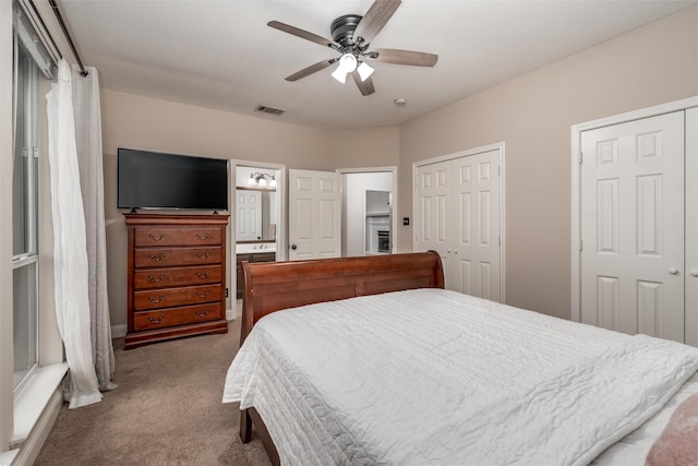 24 Shady Dale Ln, Rockwall, TX 75032 - bedroom with multiple closets, carpet flooring, connected bathroom, and ceiling fan