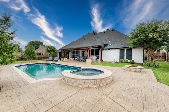24 Shady Dale Ln, Rockwall, TX 75032 - view of pool featuring a fire pit, a patio area, a fenced backyard, and a pool with connected hot tub