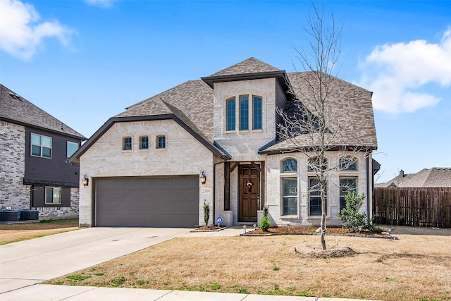 2309 Normandy Ave, Anna, TX 75409 - french country style house featuring driveway, roof with shingles, a garage, and central air condition unit
