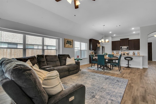 2309 Normandy Ave, Anna, TX 75409 - living room with a ceiling fan, a chandelier, light wood finished floors, arched walkways, and baseboards