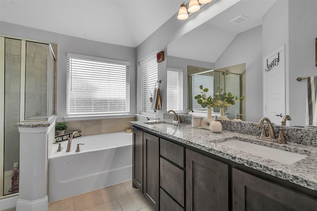 2309 Normandy Ave, Anna, TX 75409 - bathroom with vaulted ceiling, a stall shower, double vanity, a garden tub, and tile patterned flooring