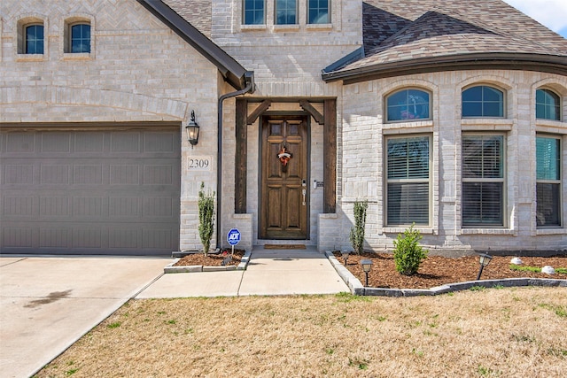 2309 Normandy Ave, Anna, TX 75409 - entrance to property with driveway, a shingled roof, and stone siding