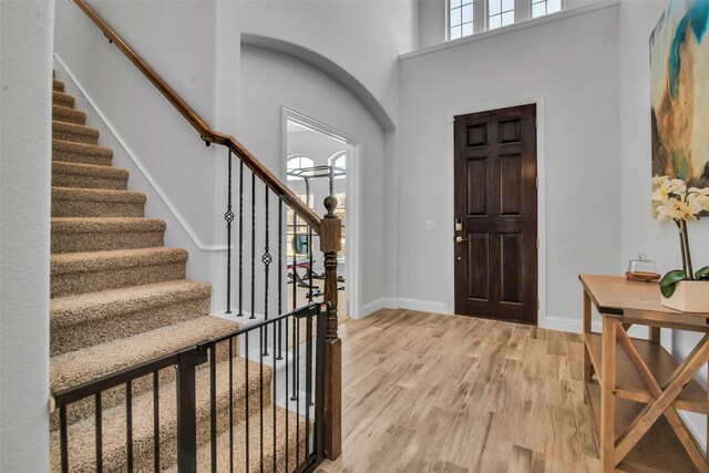 2309 Normandy Ave, Anna, TX 75409 - foyer featuring light wood-type flooring, stairs, baseboards, and a towering ceiling