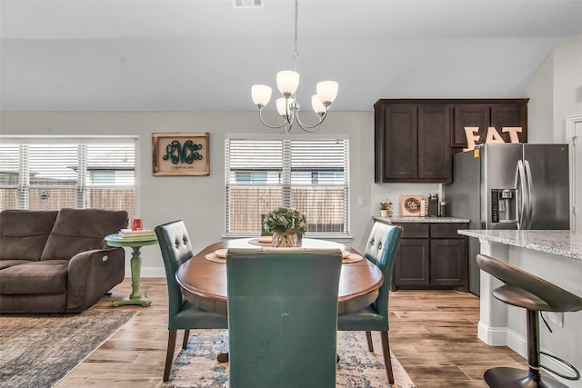 2309 Normandy Ave, Anna, TX 75409 - dining area featuring a chandelier, plenty of natural light, light wood finished floors, and lofted ceiling