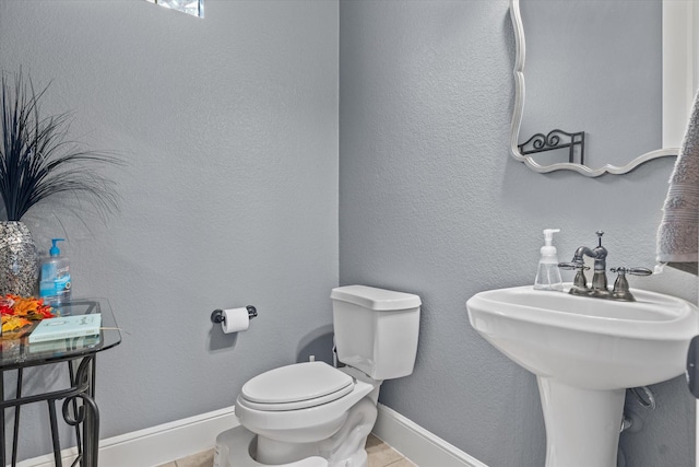 6500 Lazy Oak Ln, Plano, TX 75024 - half bathroom featuring toilet, tile patterned floors, and baseboards