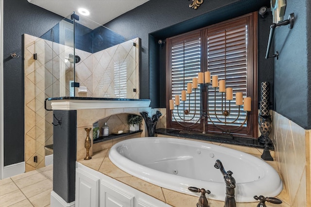 6500 Lazy Oak Ln, Plano, TX 75024 - full bathroom featuring a stall shower, a whirlpool tub, tile patterned flooring, and a textured wall