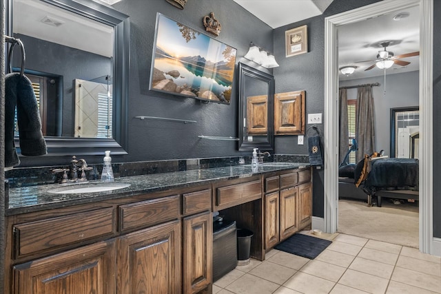 6500 Lazy Oak Ln, Plano, TX 75024 - bathroom with ensuite bath, tile patterned floors, double vanity, a textured wall, and a ceiling fan