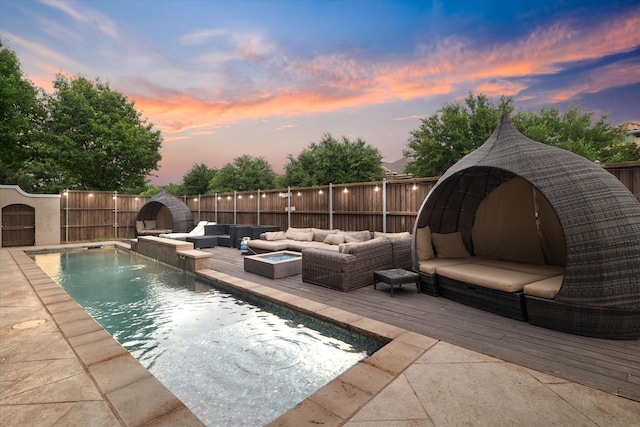 6500 Lazy Oak Ln, Plano, TX 75024 - pool at dusk with an outdoor hangout area, a fenced backyard, and a deck